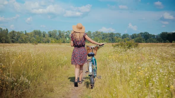 Girl Relax On Holidays Morning Vacation. Happy Woman Walking Summer Field. Cycling On Wild Grass.