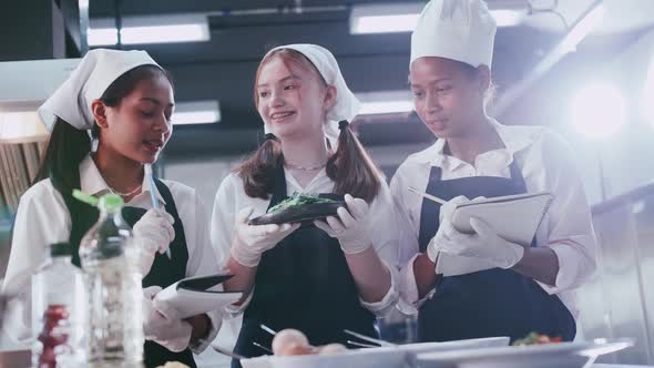 Group of schoolgirls having fun learning to cook. Female students in a cooking class.