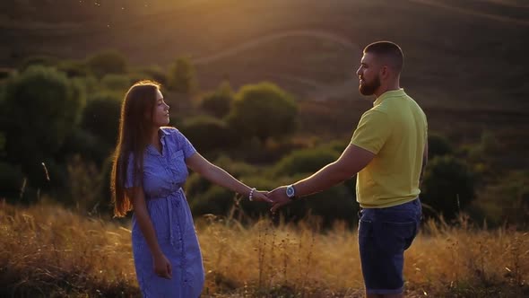 Romantic Evening of Happy Young Couple in Love on Field Under Sunset, Close-up View in Slow Motion