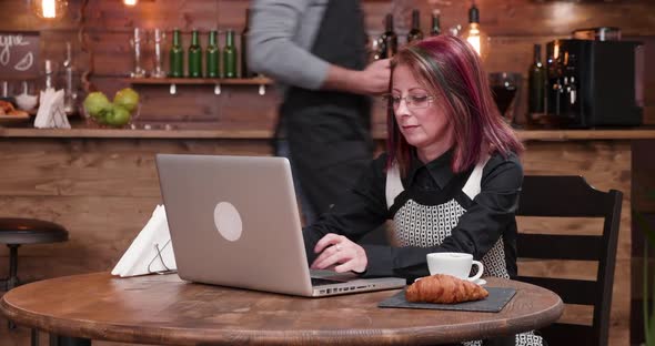 Zoom in Shot on Woman in Coffee Shop Paying with Her Smartphone