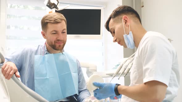 The Dentist Demonstrates the Correct Technique of Brushing Teeth