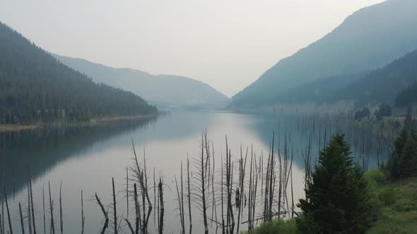 A dynamic aerial shot of the Yellowstone river moving upwards like a jib shot. The place has trees a