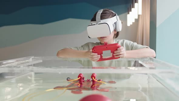 Teenage Boy Wearing VR Glasses Playing with Robo Boat