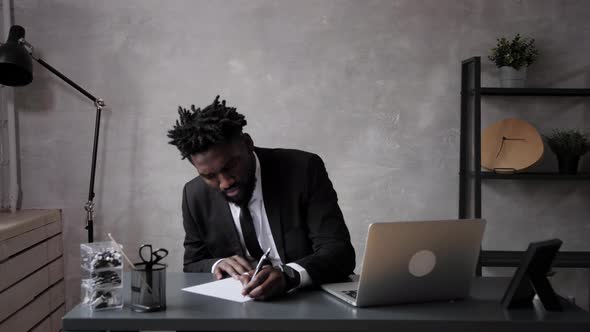 a Black Man Works at a Laptop Closeup of His Face