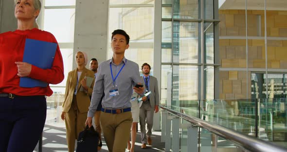 Business people walking in office building 4k