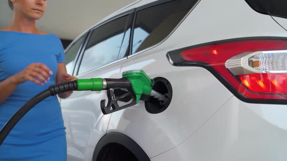 Woman Pulls Out a Refueling Gun From a Car Tank After Finishing Refueling