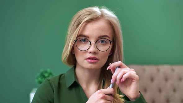 Close Up Face of Adorable Woman in Glasses Posing at Office