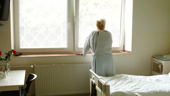 Senior woman standing near window