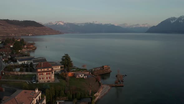 Flying over lakeside houses towards a vast and beautiful lake