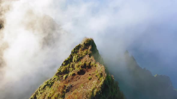 Cinematic Flight Above Green Peak Through White Fog Clouds. Sunset on Hawaii