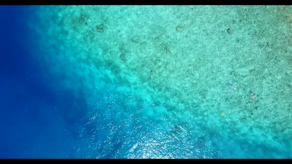 Aerial top down sky of beautiful resort beach break by blue water with clean sandy background of a d