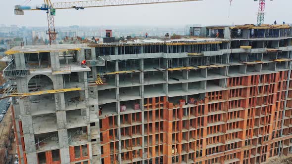 Massive residential building at construction site. Drone aerial view of new development 