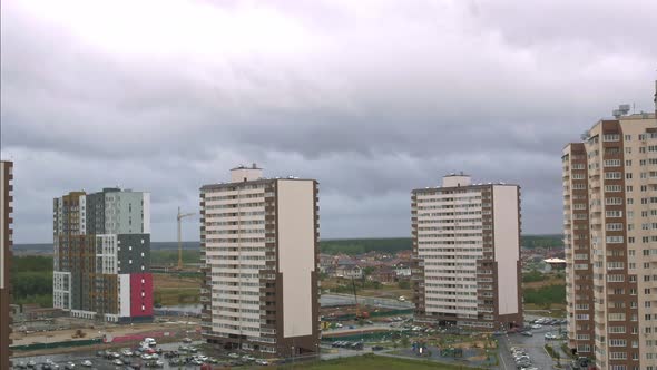 Timelapse of a Residential Area of the City with High Apartment Complexes and Private Houses Despite
