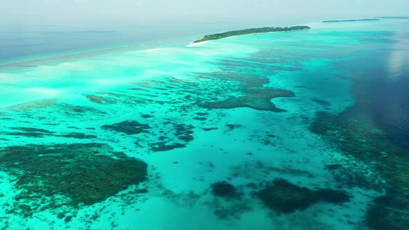 Daytime overhead abstract shot of a sunshine white sandy paradise beach and blue ocean background in