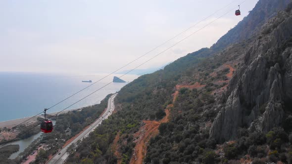 Close-up Flight Next To the Uphill Funicular with the Coast in the Background 