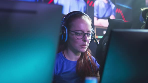 Female Gamer Speaking with Teammates During Video Game Match