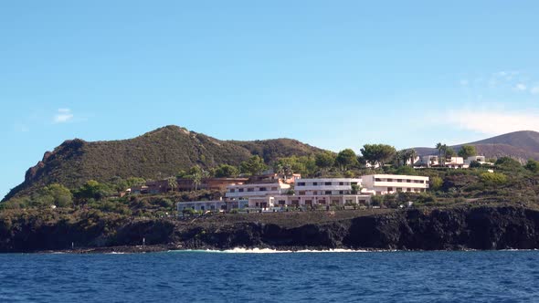 View From Moving Sailing Yacht on Mountains with Huge Hotel