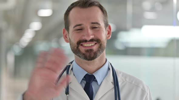Portrait of Friendly Male Doctor Talking on Video Call 