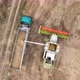 Aerial View of Combine Harvester Unloading Grain in Cargo Trailer Working During Harvesting Season - VideoHive Item for Sale