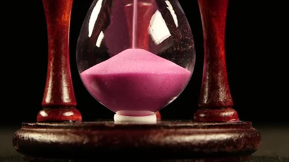 Sand Completely in the Bottom of the Hourglass. Black. Slow Motion. Close Up
