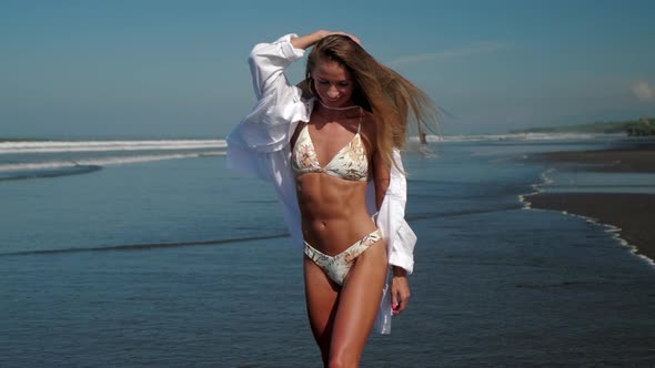 Pretty Sexy Lady in Bikini and White Shirt on Ocean Beach