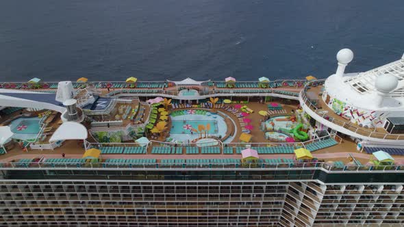 Aerial trucking shot over the main deck of the giant cruise ship