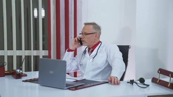 Physician talks the phone in clinic.