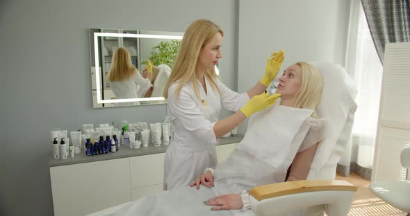 Beauty Industry Concept. Beautician Preparing Patient To Skin Care Procedure In Spa Salon.