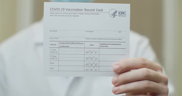Medical Healthcare Worker Holding Vaccination Record Card Risk Free Certificate Document