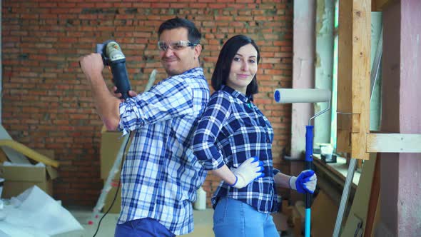 Married Couple in Plaid Shirts Ready To Be Repaired in Their Home