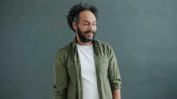 Slow Motion Portrait of Attractive Mixed Race Man Winking and Smiling Looking at Camera