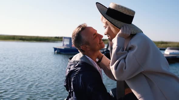 Adult Couple in Love Stand Hugging on the Pier