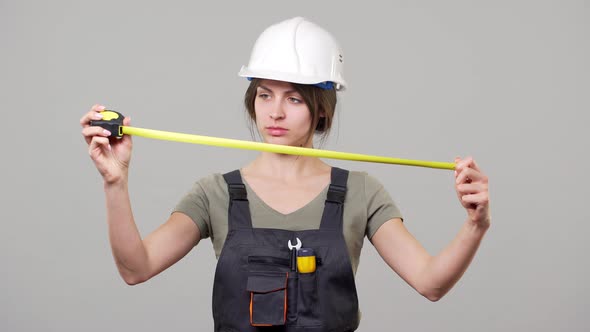 Portrait of European Young Woman Specialist in Helmet and Jumpsuit Working on Factory or Facility