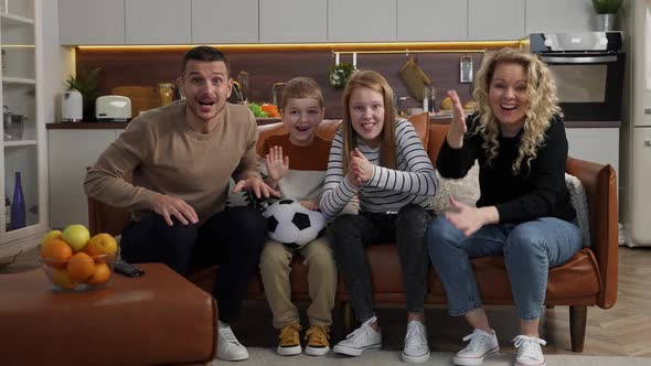 Cheerful Deafmute Family Watching Football on TV