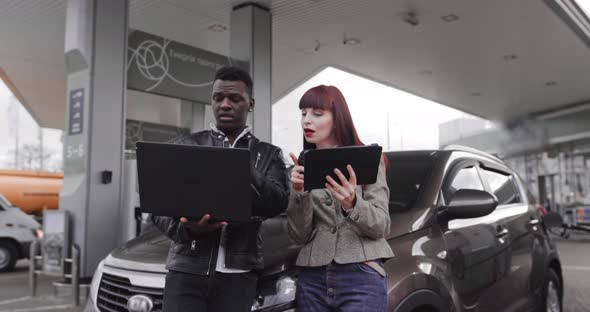 Front View of Multiracial Male and Female Friends in Casual Outfits Working on