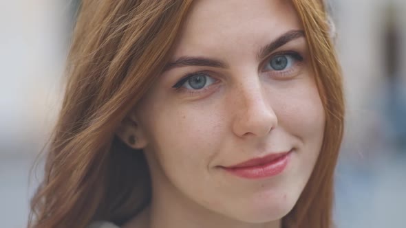 Portrait of Beautiful Redhaired Young Woman on Street in Slow Motion