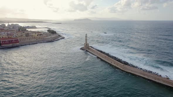 Cinematic sunset shot of lighthouse in the old Venetian port of Chania. Epic Aerial Drone footage