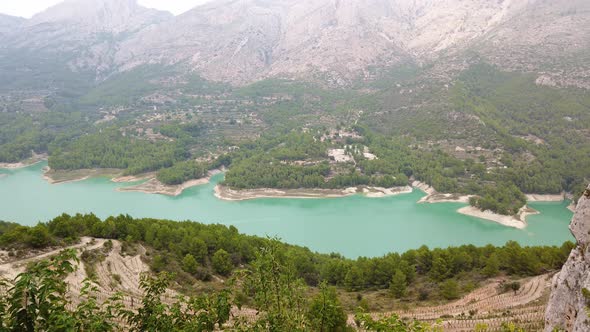 Mountain Lake with Turquoise Water and Green Tree.