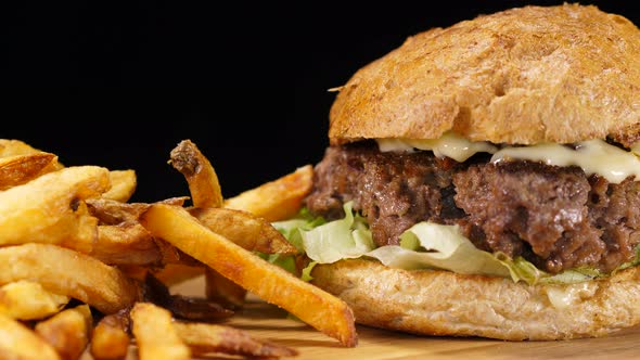 Close Up of a Grilled Hamburger with Onions and French Fries