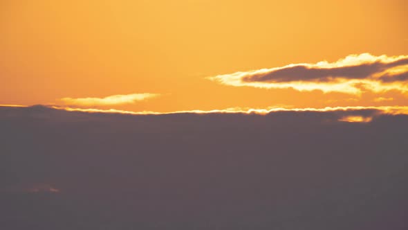 Telephoto lens Close up the sun in sunset time-lapse 4k. Clouds and sun rising sky night to day