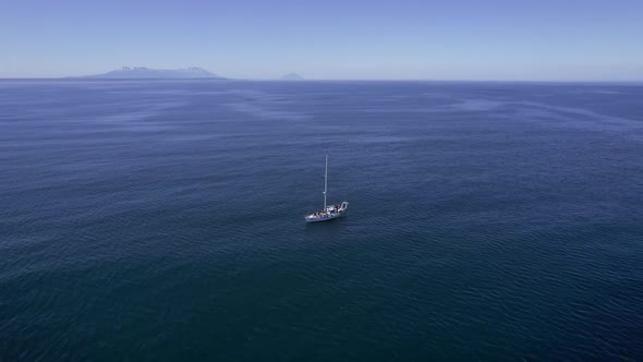 Circling Shot From Drone of Yacht in a Middle of Oceanic Landscape