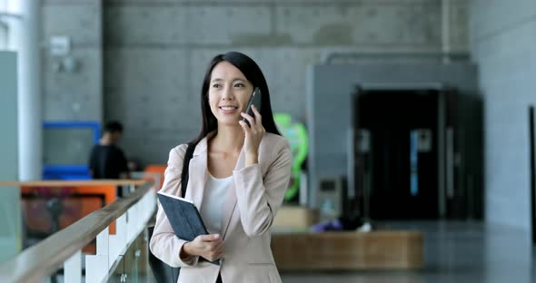 Business woman holding tablet and talk to cellphone 