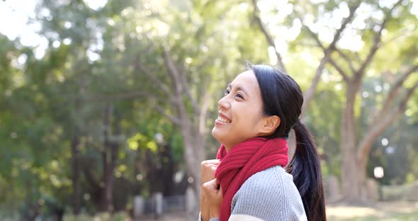 Excited woman cheer up in the city park