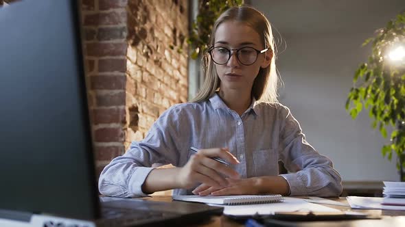 Caucasian Young Woman Using Tablet Computer at the Modern Office