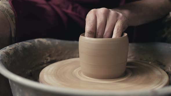 The Hands of a Potter Creating an Earthen Jar on the Circle Closeup Hands on Circle with Clay