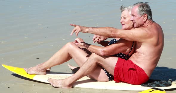 Senior couple sitting on the beach