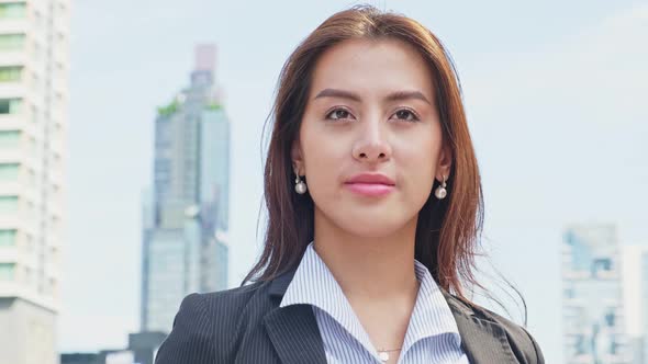 Portrait of Asian young smart business woman working in company office in city and look at camera.