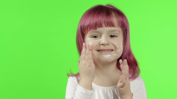 Caucasian Child Girl Using Cream. Puts Cream on Her Face. Skin Care. Chroma Key