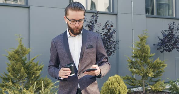 Man in Stylish Suit which Standing Outdoors and Talking on Phone