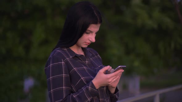 Blogger Woman Using Smartphone Texts Scrolls Surf Internet Search News on Street